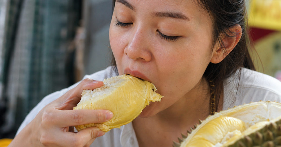 Woman eating durian