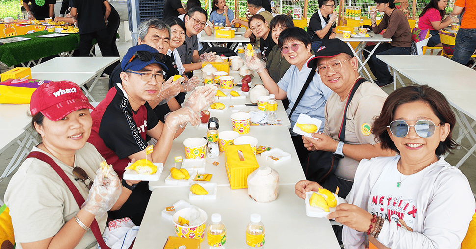 A group of happy people eating durian